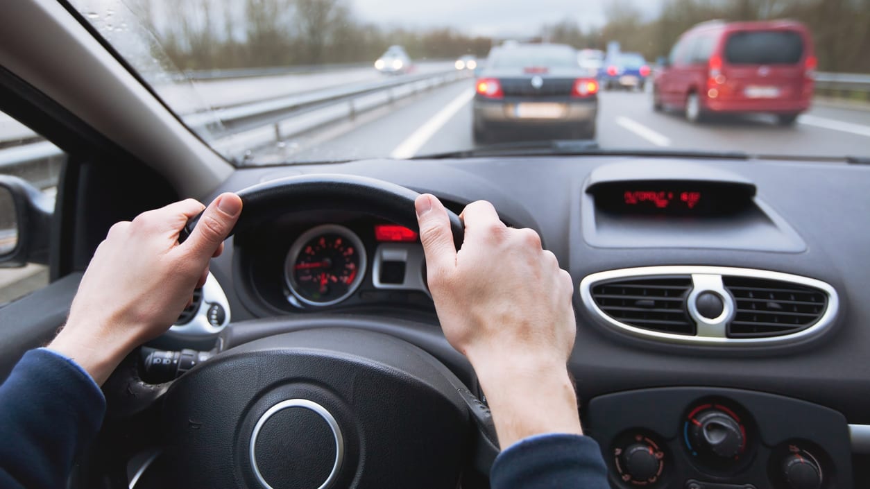 A person driving a car on a highway.