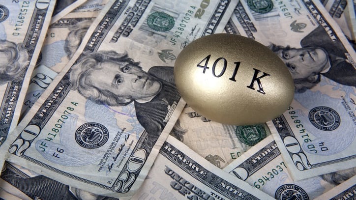 A golden egg sits on top of a pile of dollars.