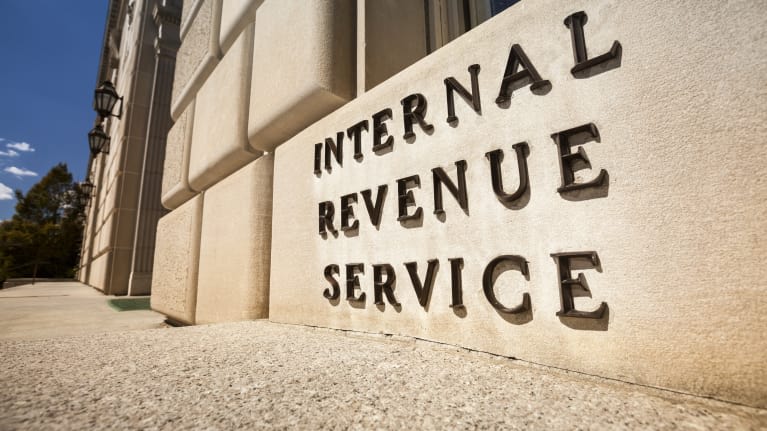 The irs sign is in front of a building.