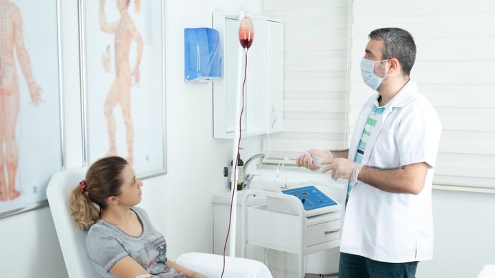 A doctor is giving a blood test to a patient.