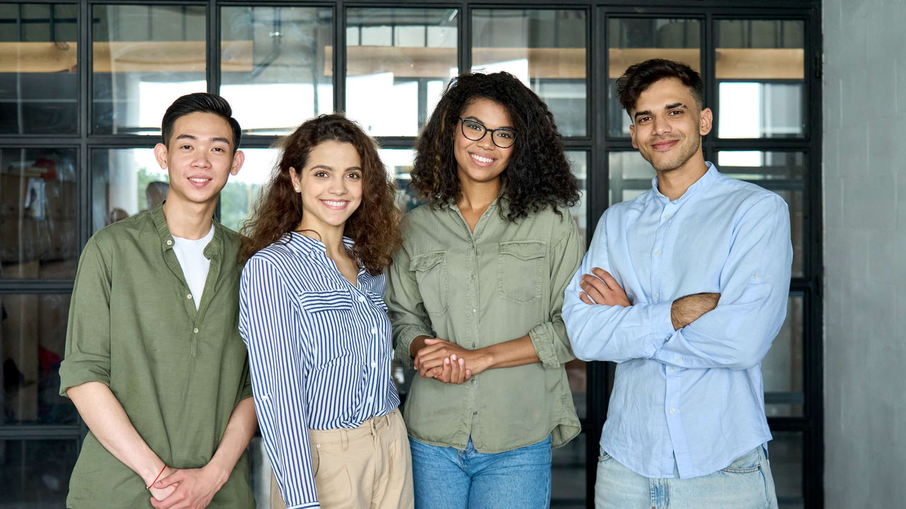 A group of people standing together in an office.