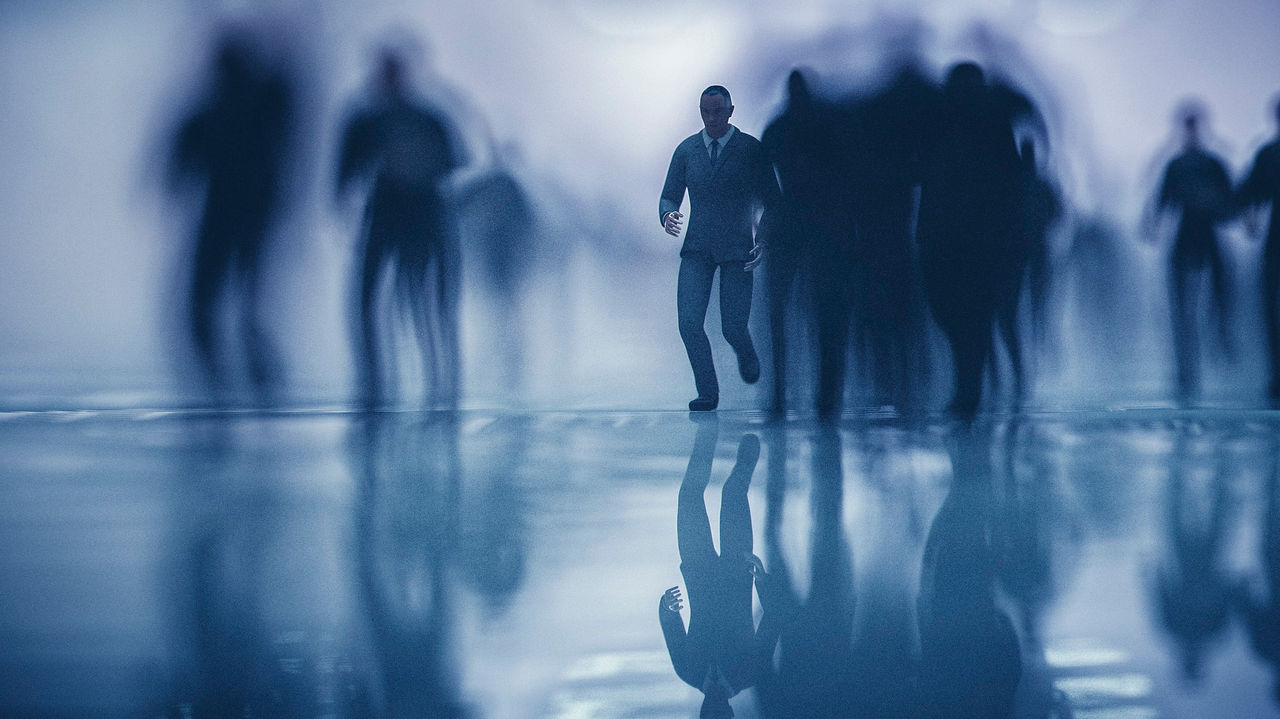 A group of people walking in a dark hallway.