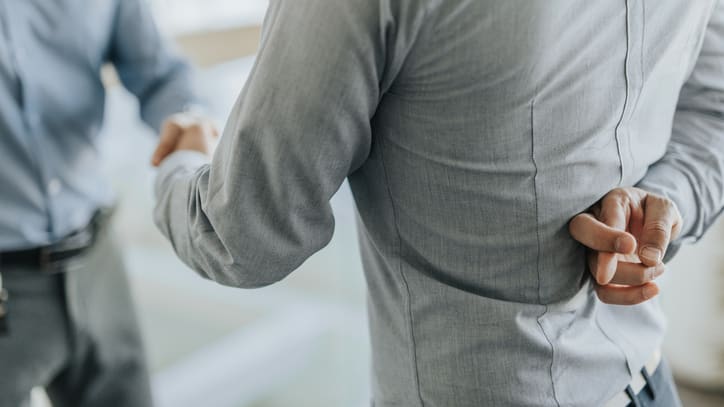 Two businessmen shaking hands in an office.