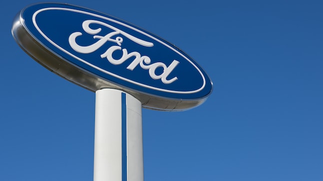 A ford logo is shown against a blue sky.
