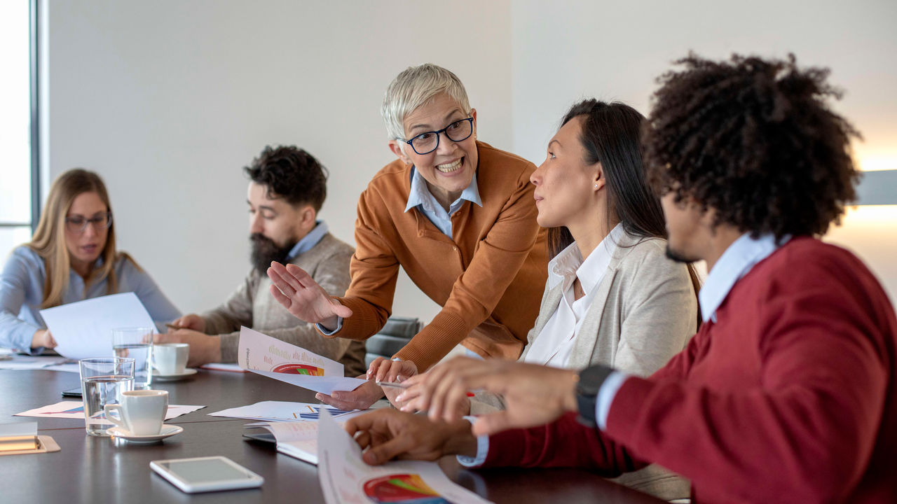 A group of people sitting around a conference table.