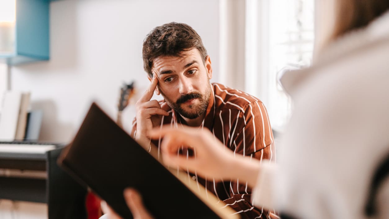 A man is talking to a woman on the phone.