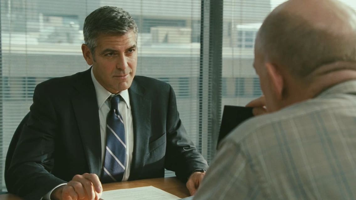 Actor George Clooney at a desk.