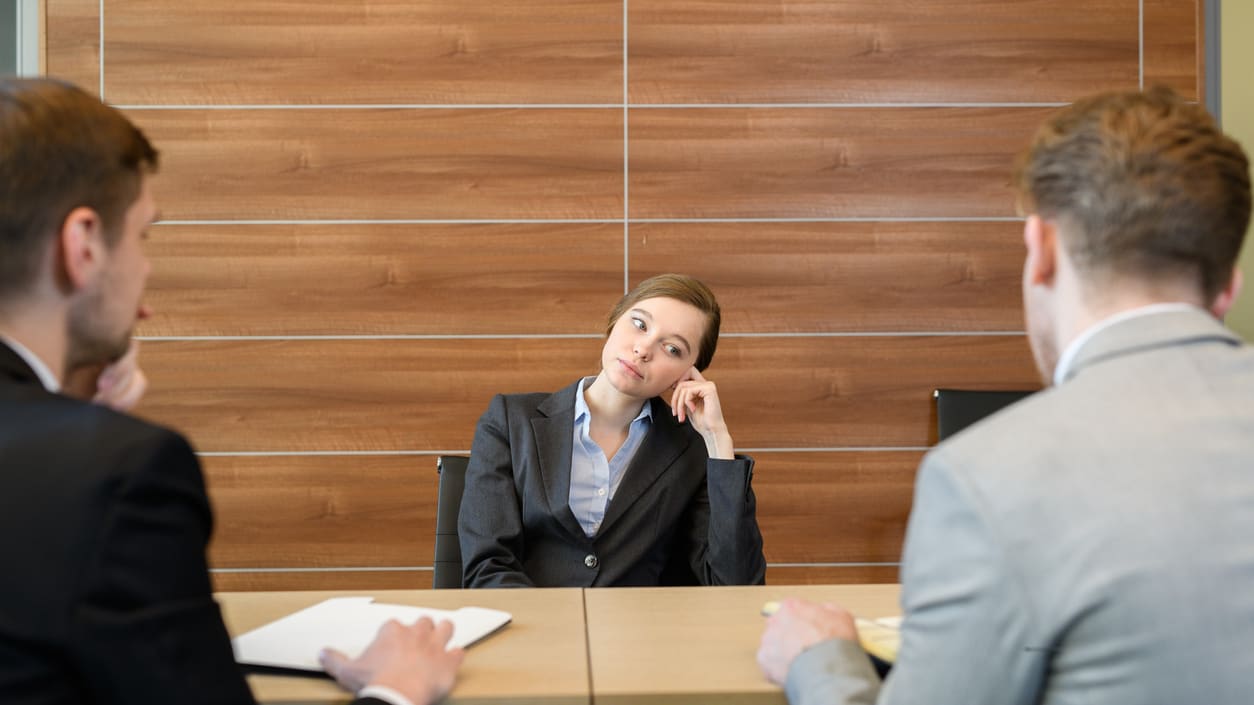 A group of business people sitting at a table in a conference room.