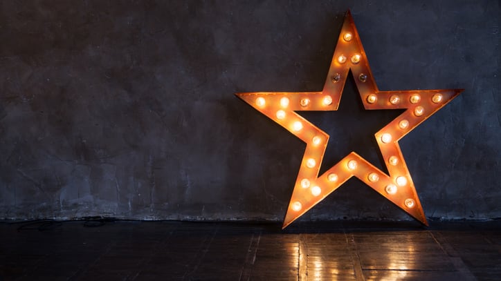 A star shaped light up sign in a dark room.