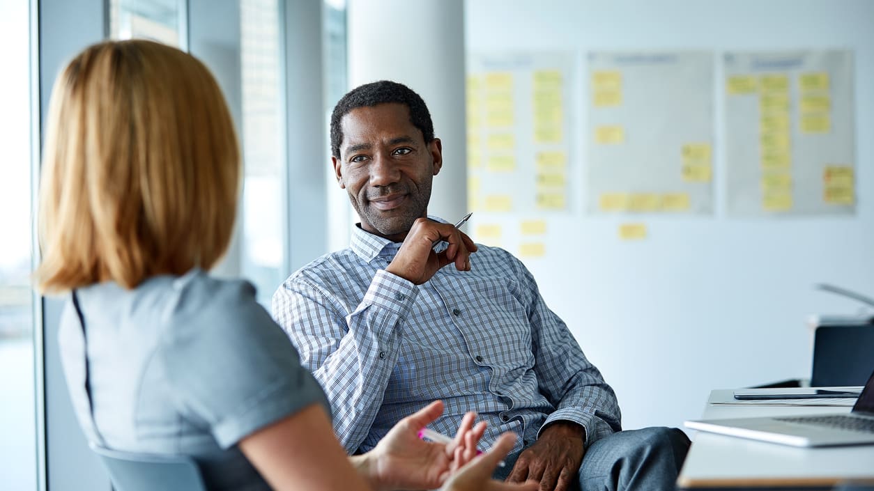 Two business people talking in an office.