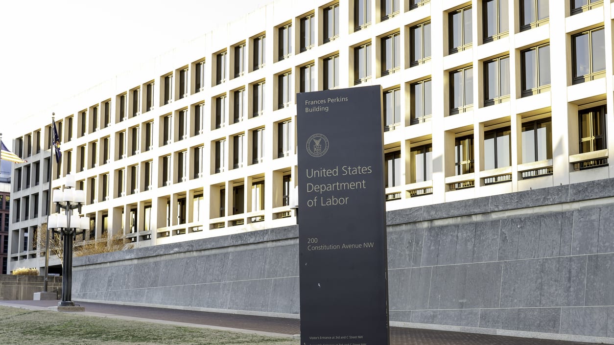 A large building with a sign in front of it.