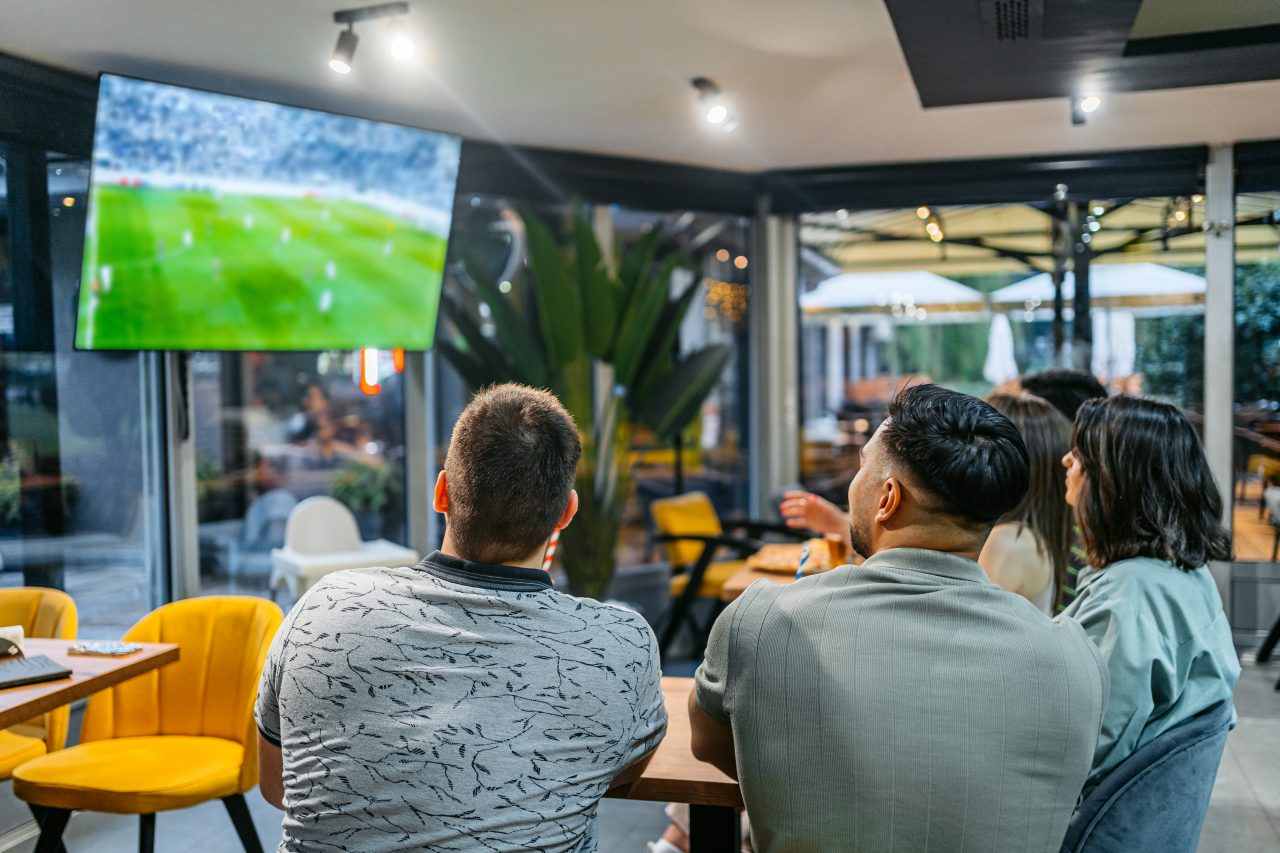 EMPLOYEES WATCHING WORLD CUP ON TV IN OFFICE