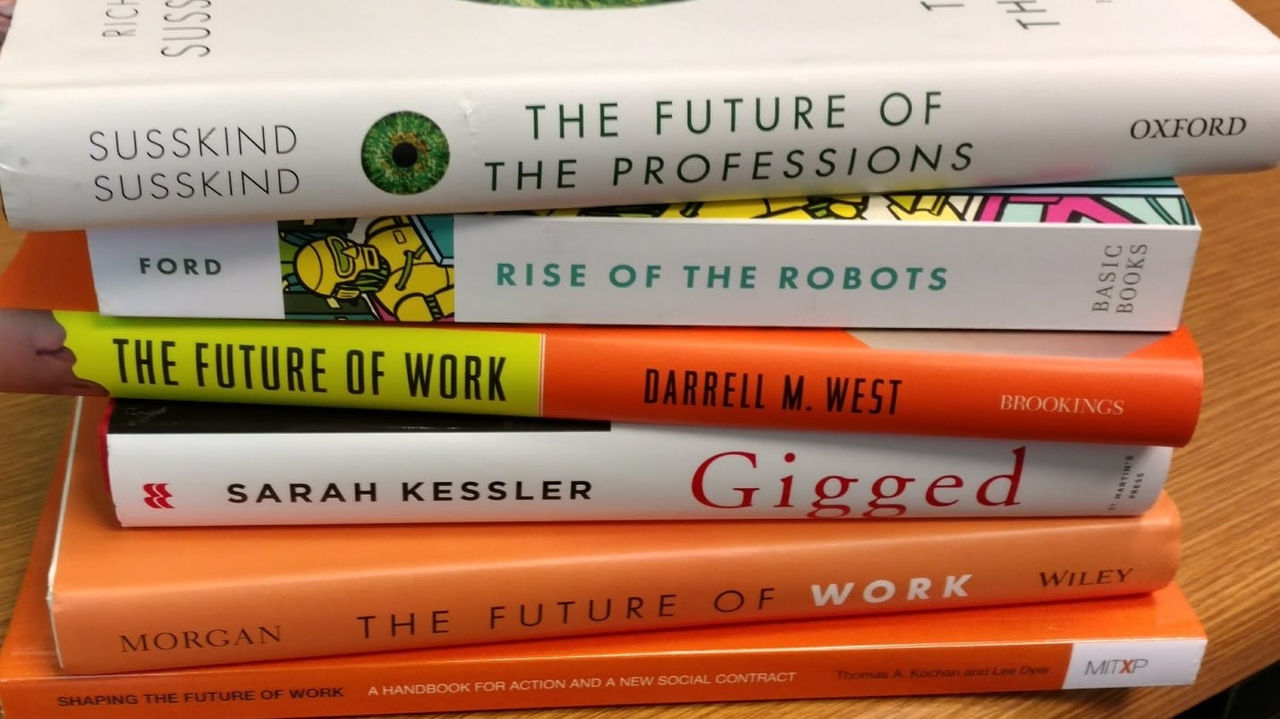 A stack of books on a desk.