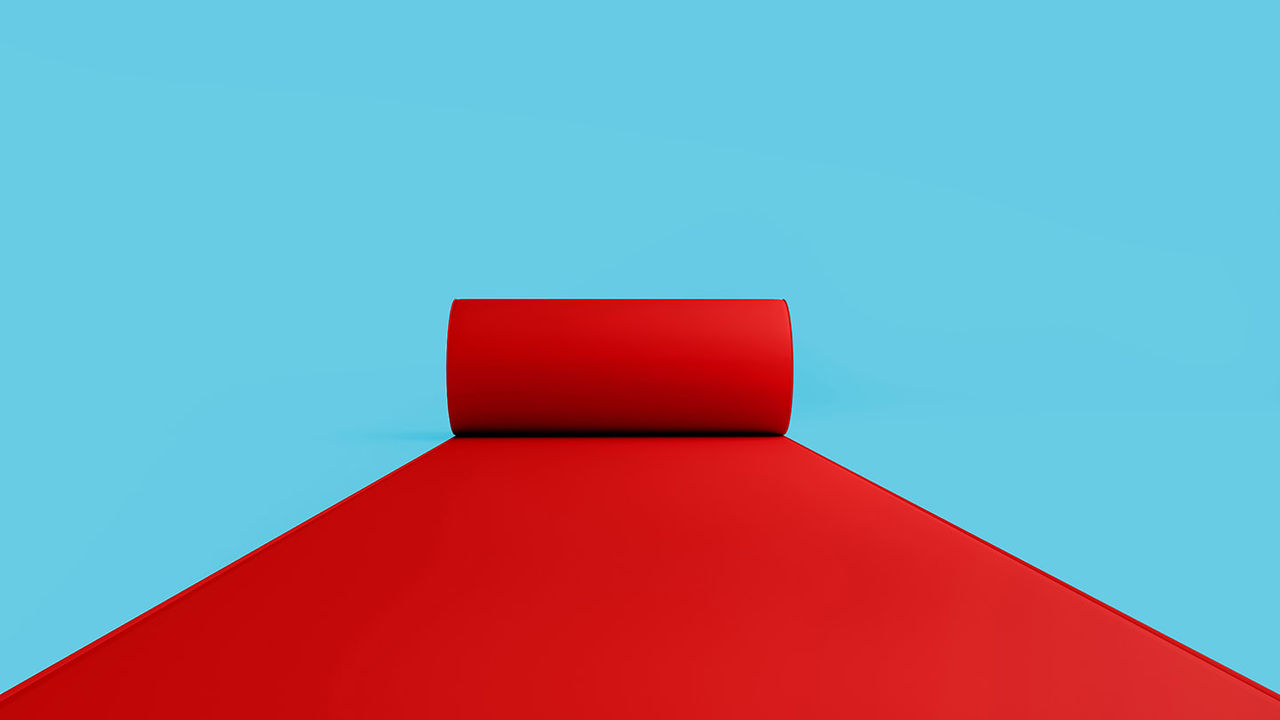 A red carpet on a blue background.