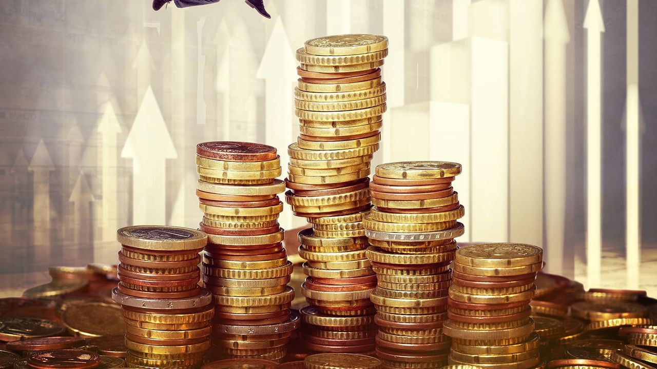 A man jumping on top of stacks of coins.