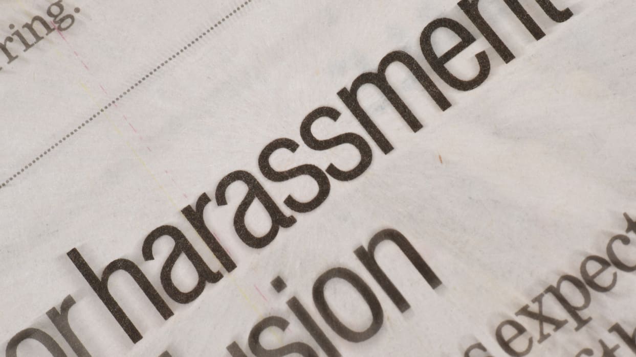 A newspaper with the word for harassment written on it.