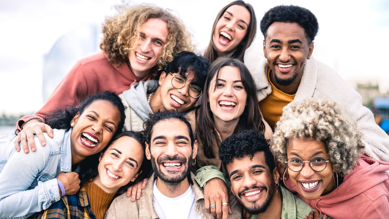 A group of young people smiling together.