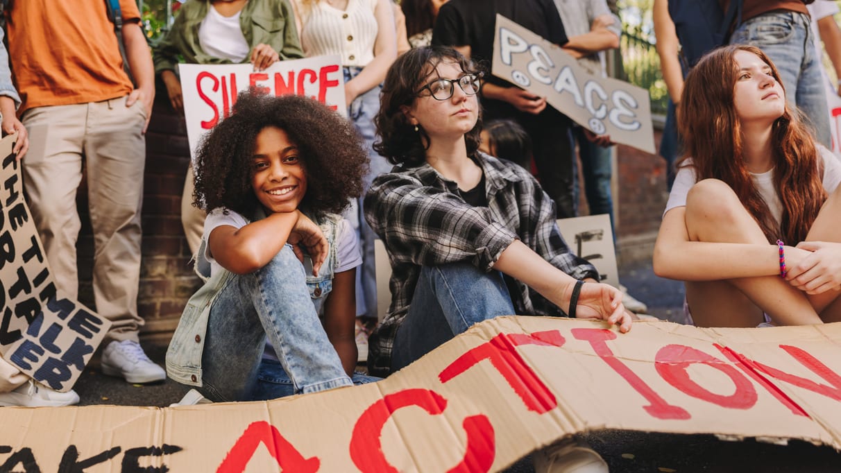 A group of people holding signs that say take action.