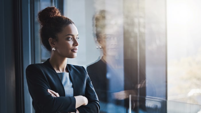 A business woman looking out of a window.