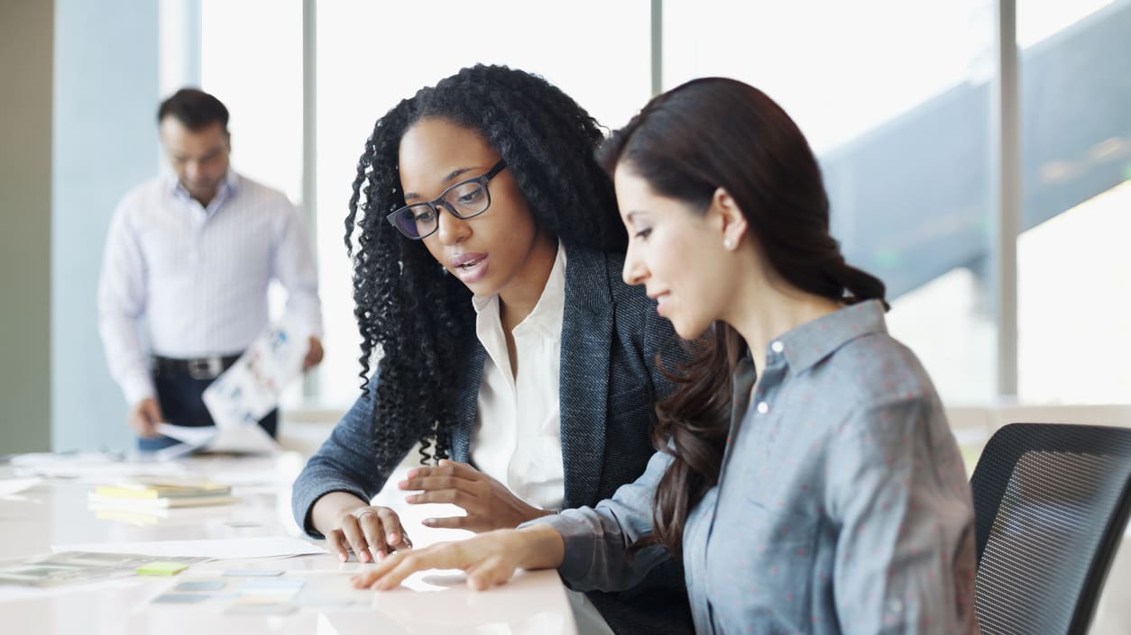 A group of business people working together in an office.