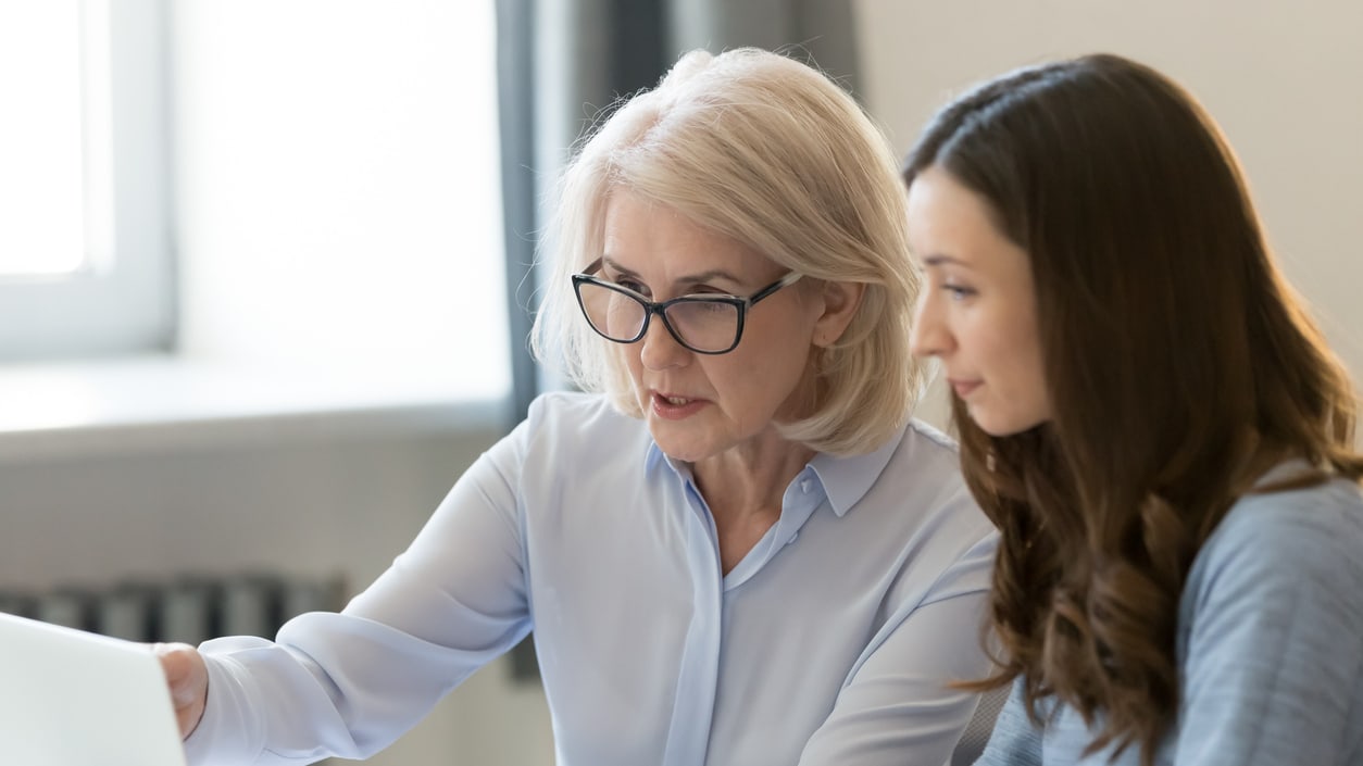 Two women looking at a laptop.