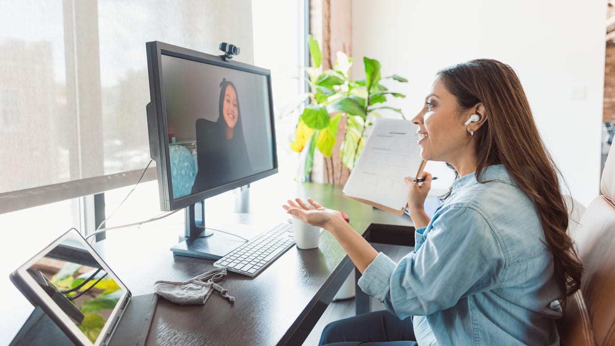 A woman is watching a video on her computer.