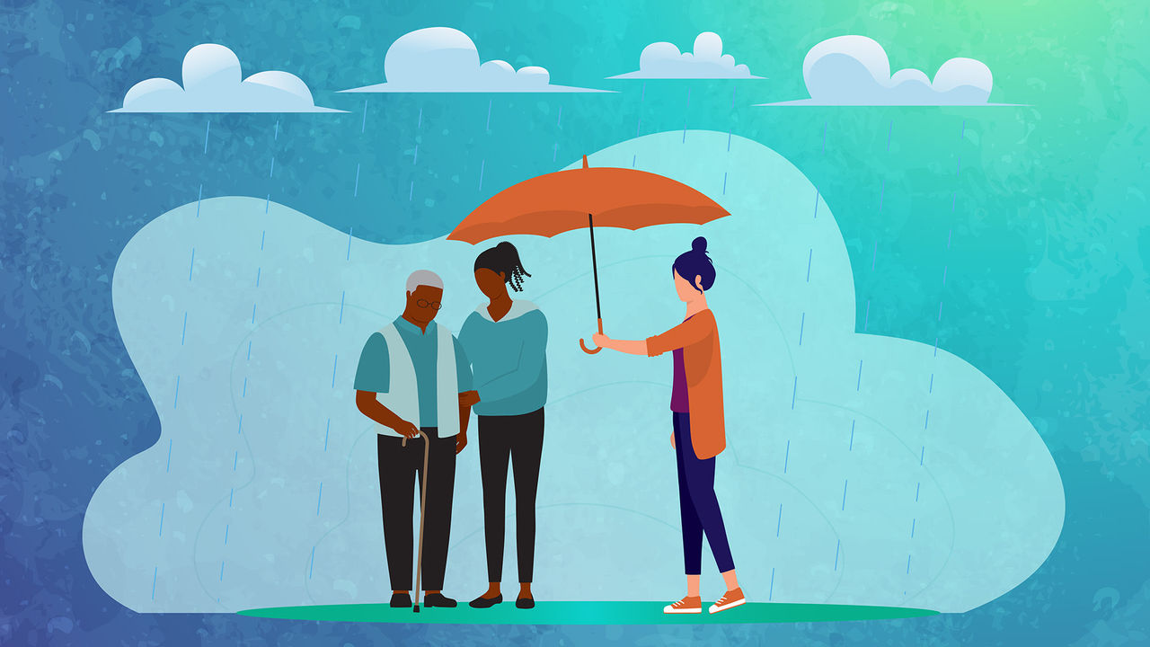 A man and woman holding an umbrella in the rain.