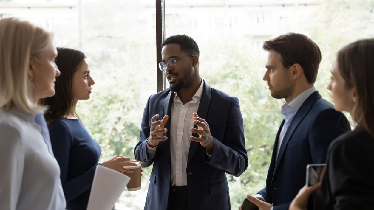 A group of business people talking in an office.