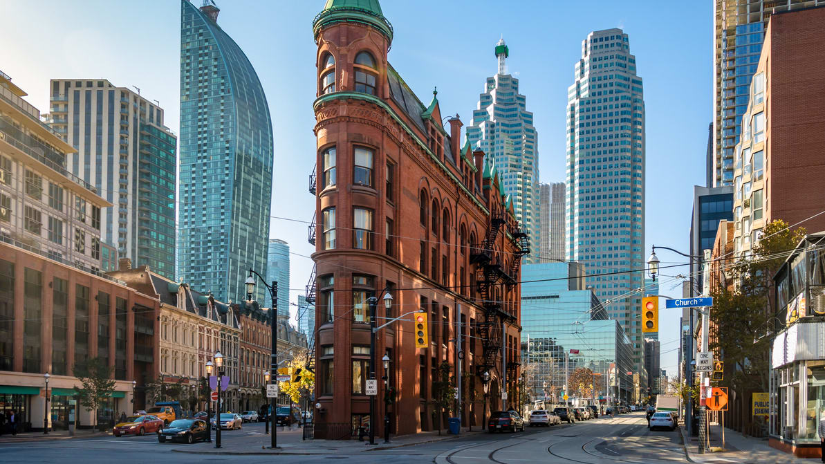 A city street with tall buildings in the background.