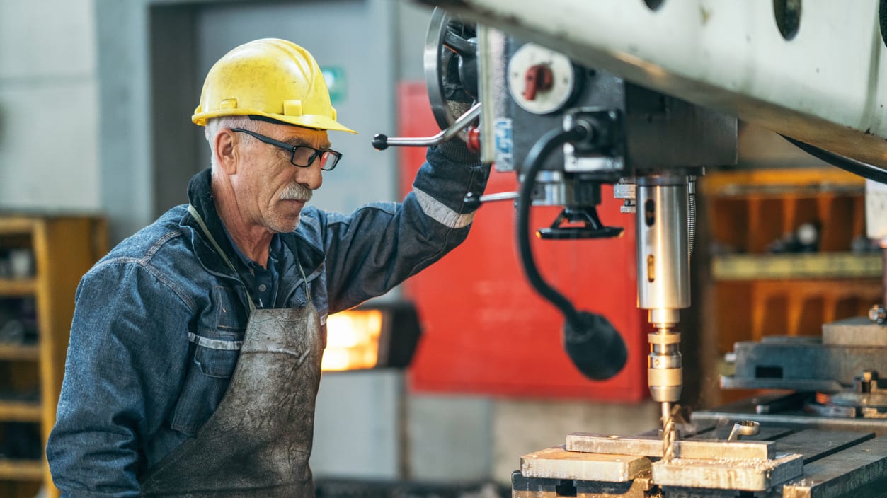 A man working on a machine in a factory.