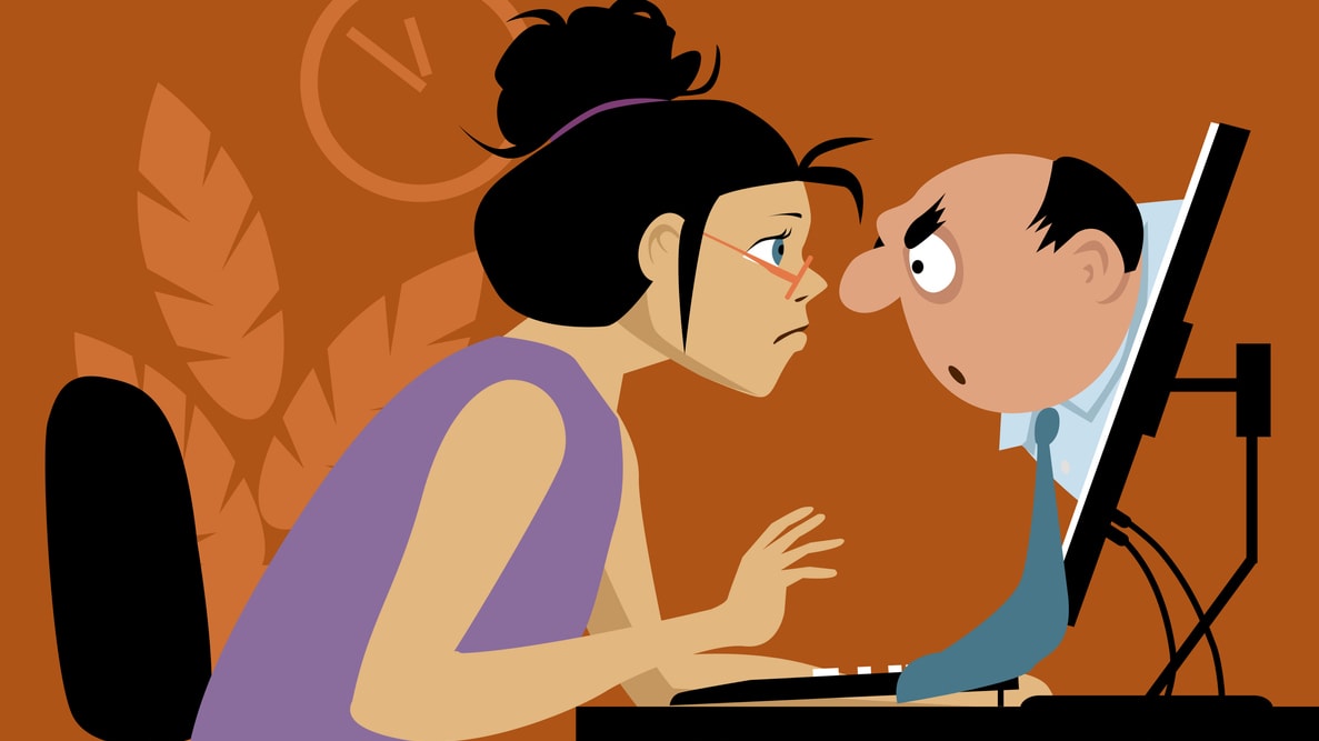 A woman is looking at a man on a computer.