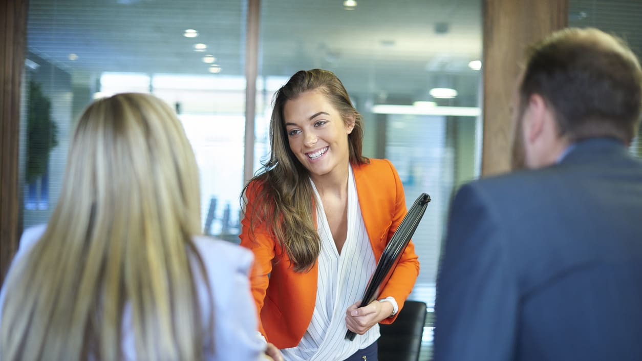 A group of business people shaking hands in an office.