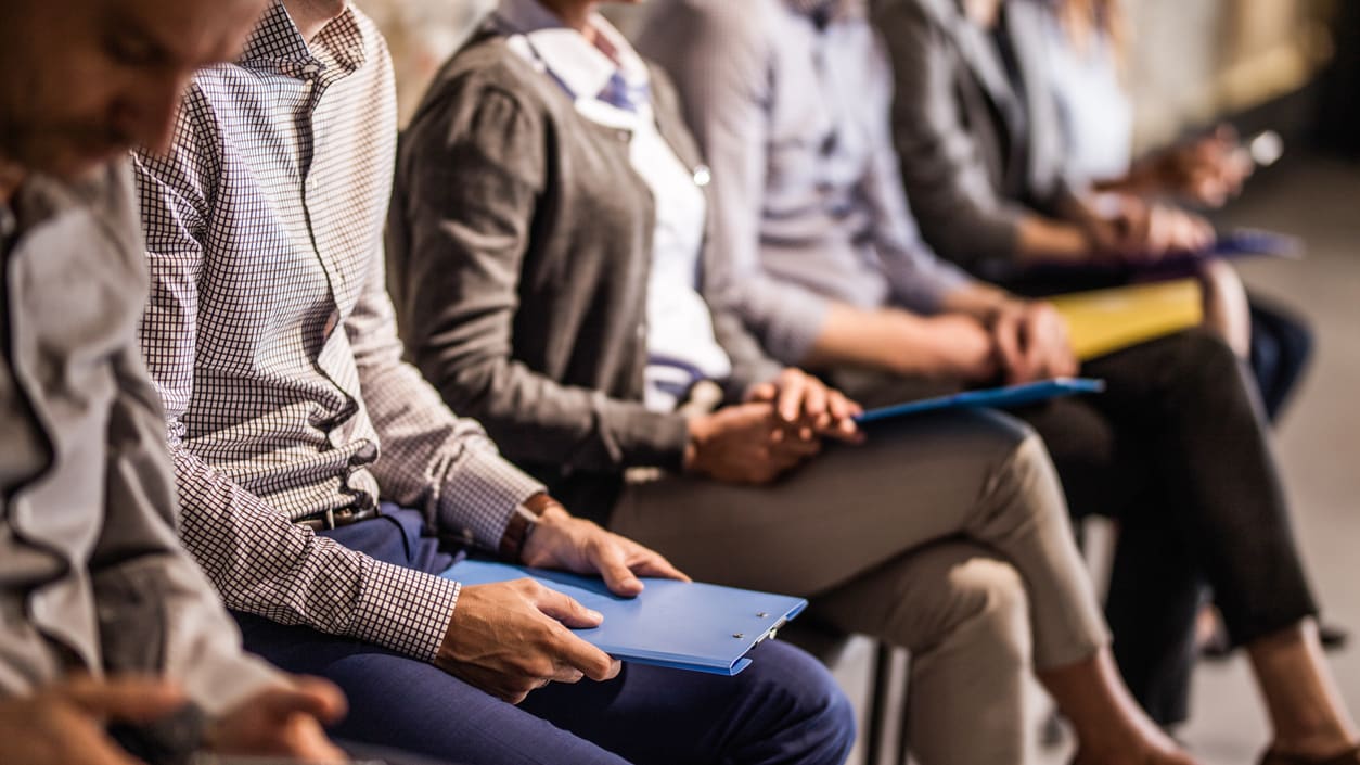 A group of business people sitting in a row.