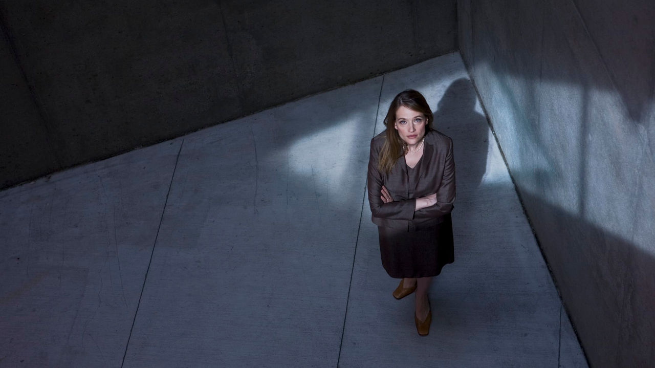 An image of a woman standing in a dark room.