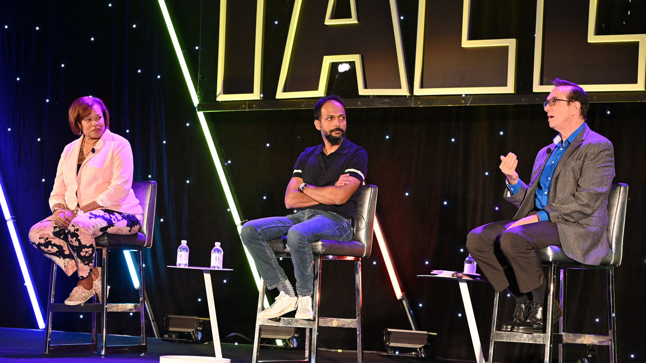 A group of people sitting on chairs at a star wars event.