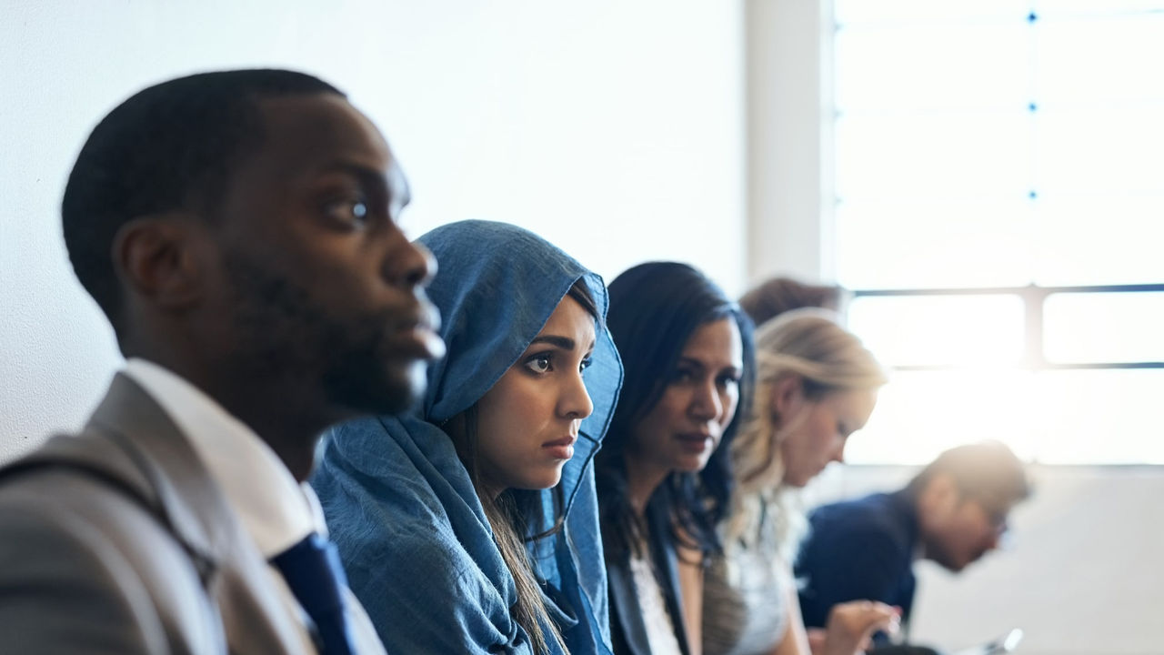 A group of business people sitting in a line.