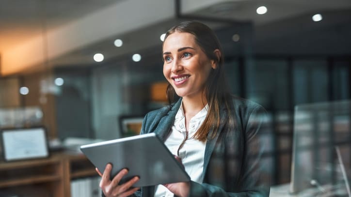 A business woman using a tablet computer in an office.