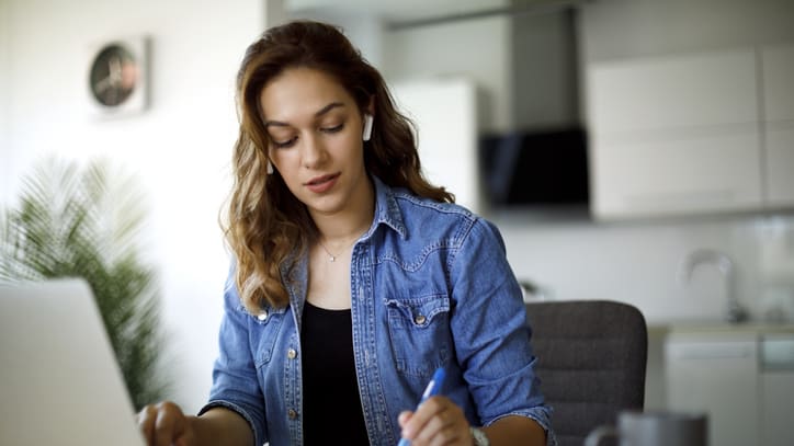 A woman working on her laptop at home.