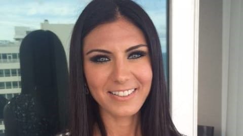 A woman in a sequin dress posing for a photo.