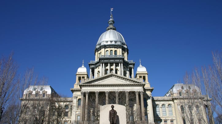 A large building with a statue in front of it.