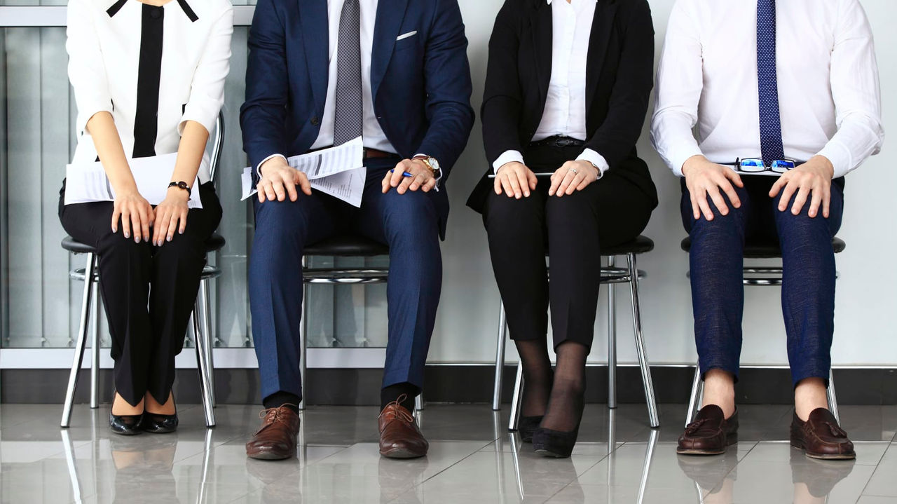 A group of business people sitting in a row.