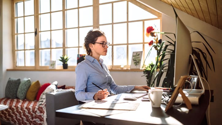 A woman working at her desk in her home office.