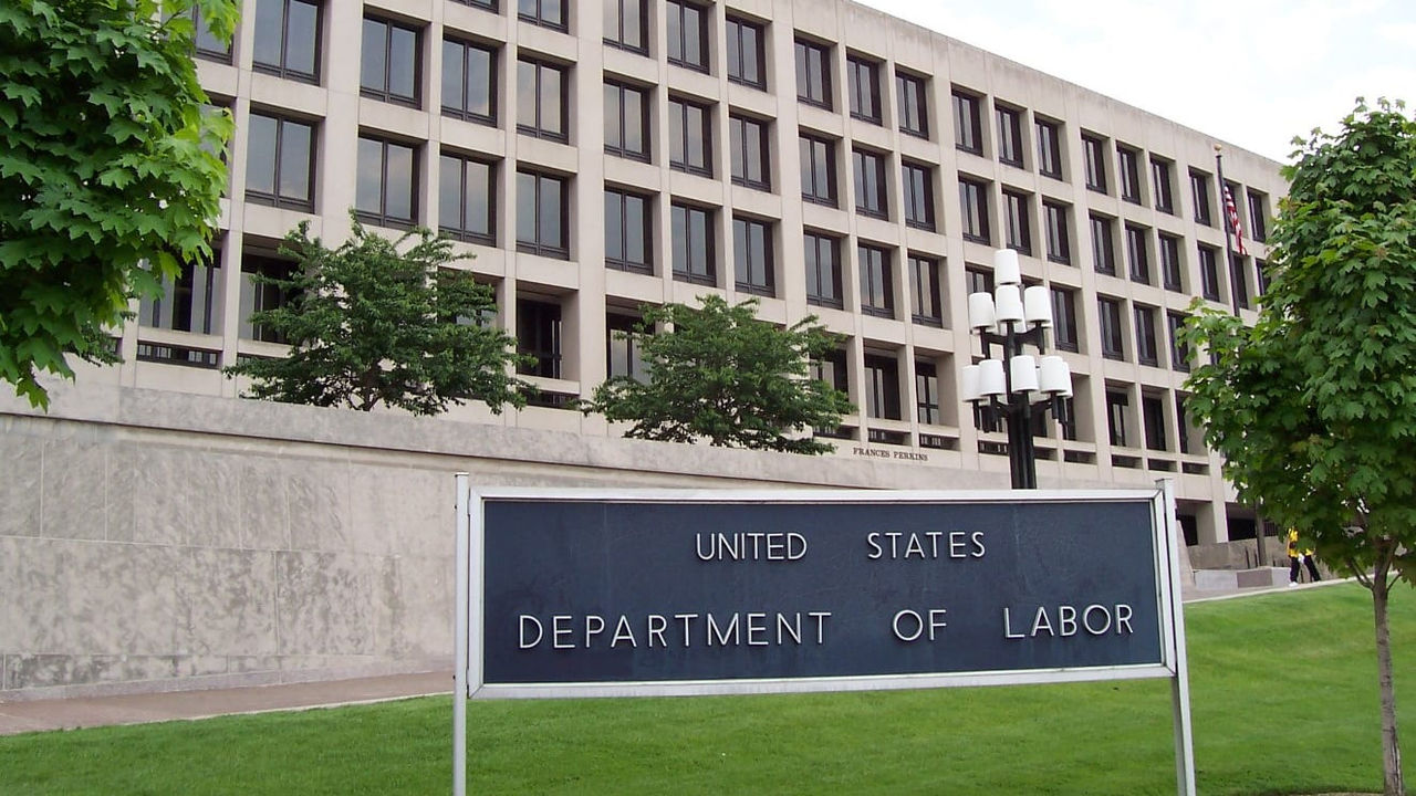 The department of labor sign is in front of a building.