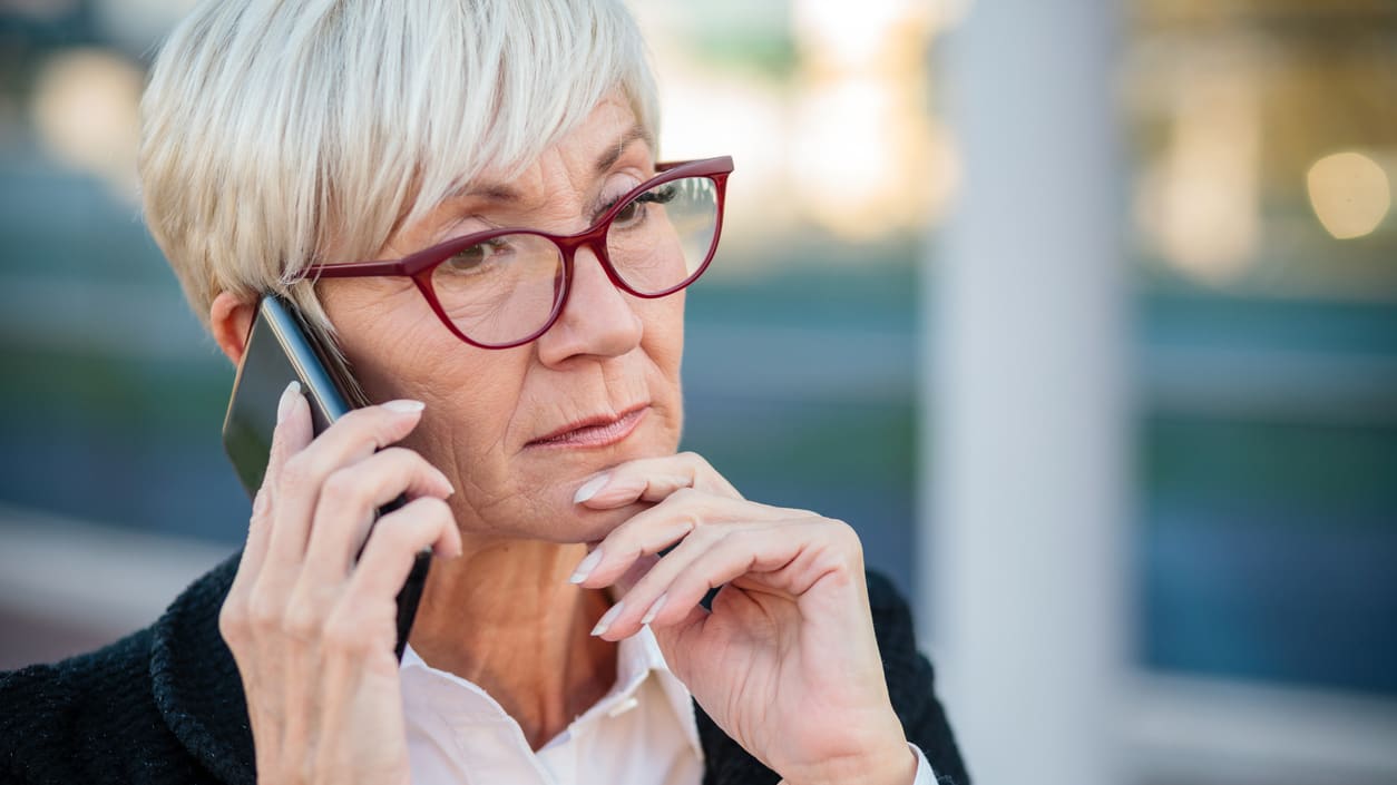 A woman in glasses is talking on her cell phone.