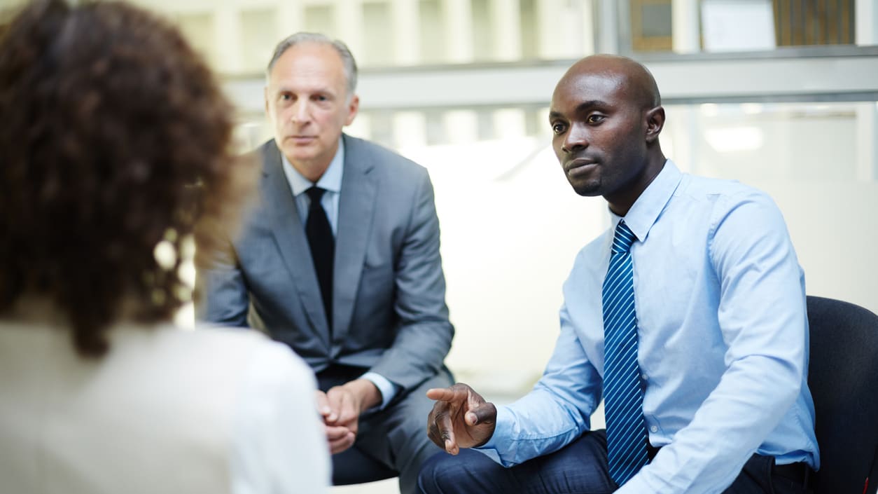 A group of business people talking in an office.