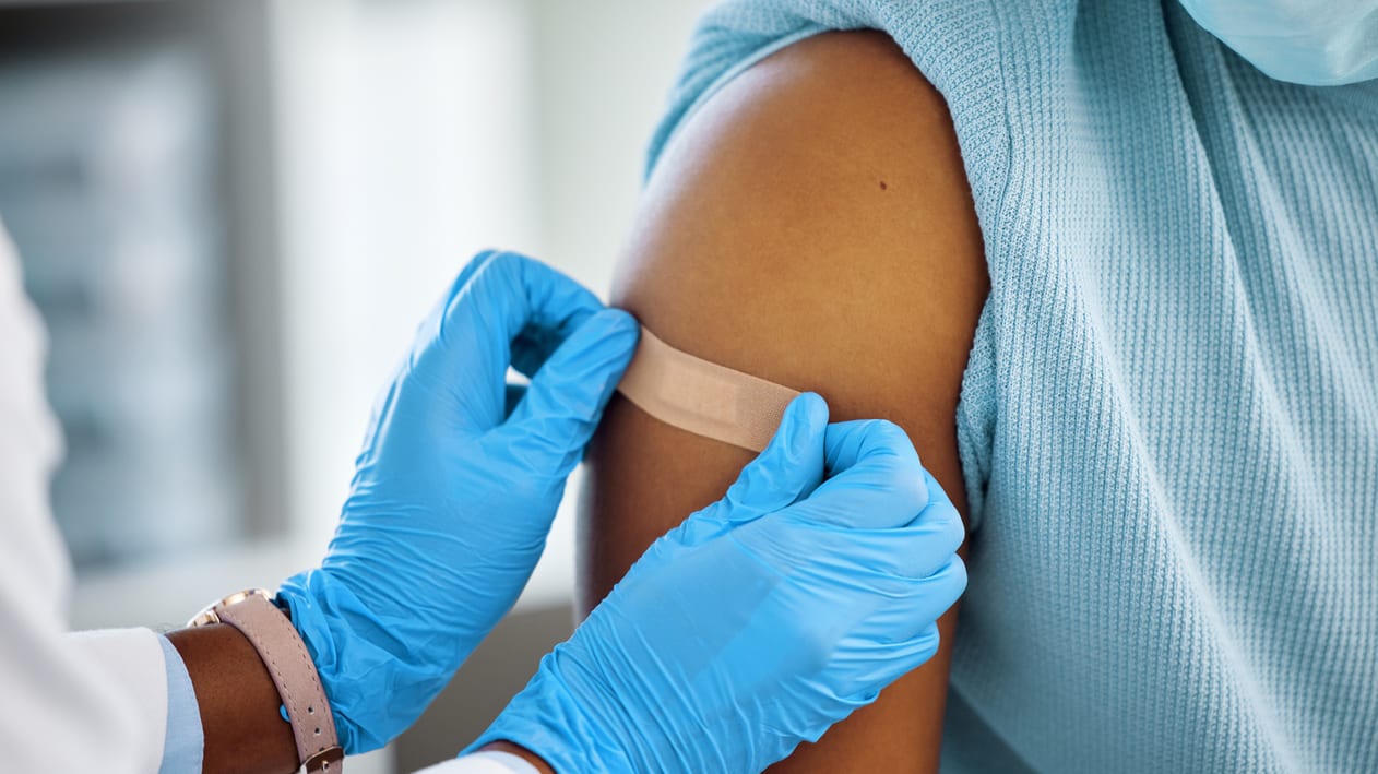 A doctor giving a vaccine to a patient.