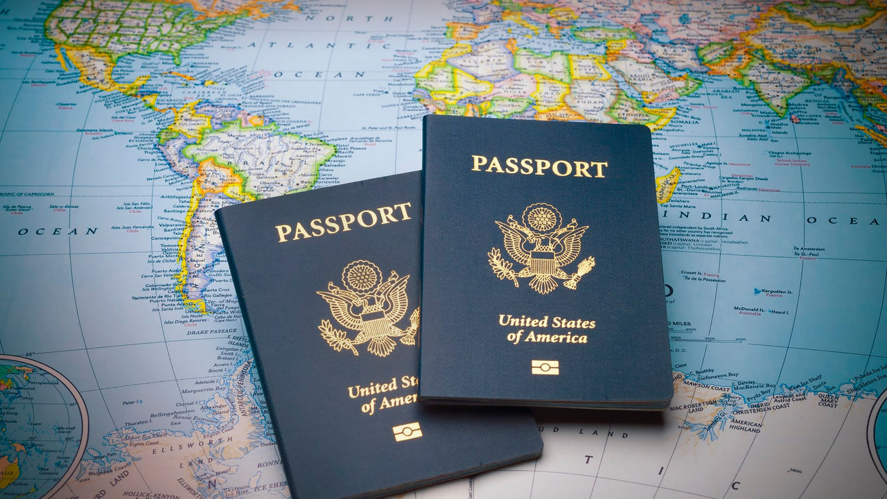 Two passports on top of a world map.
