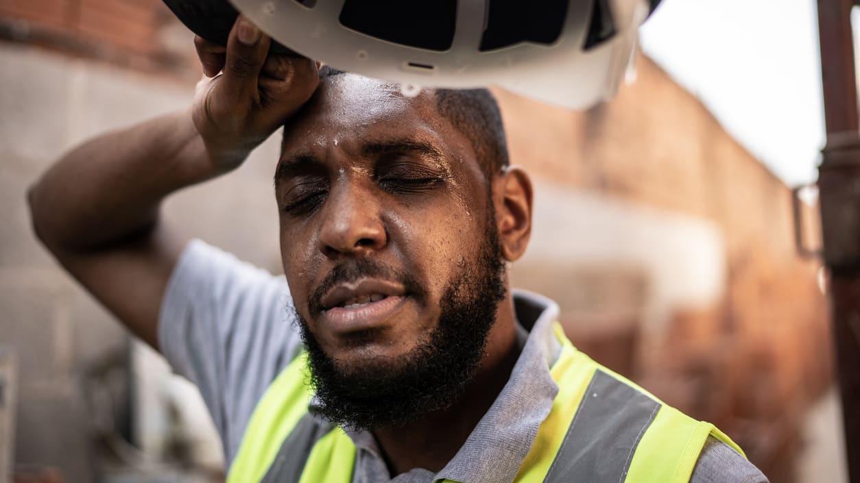 A construction worker with a hard hat on his head.