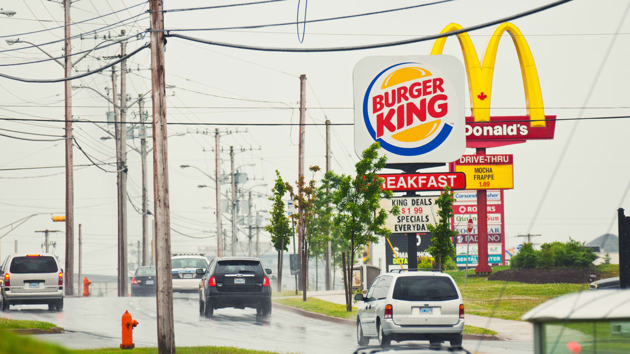 A street with a burger king sign.