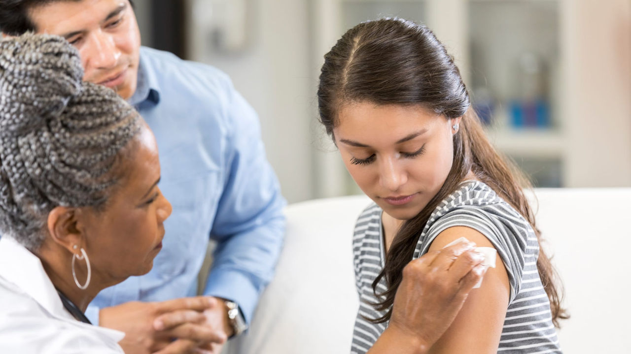 A woman is being examined by a doctor.